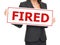 Unemployment - woman holding Fired sign on white