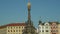 UNESCO heritage plague column holy trinity, people walk around the square Horni namesti, cultural national architectural