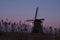 UNESCO World Heritage windmill stands as moon shines in Kinderdijk, near Rotterdam Netherlands