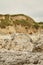 Uneven eroded rocky Dalmatian shore: sharp stones facing shimmering Sea with scattered dry vegetation on a glorious sunny Summer d