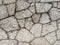Uneven stone rock tile bricks for wall facade or ground flooring for exteriors and outdoors with signs of decay and age