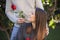 Unexpected moment in routine everyday life! Cropped photo of man`s hands giving red rose to happy girlfriend