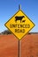 Unfenced Road warning sign indicating likely sheep and cattle on the road ahead.
