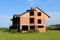 Unfinished brick family suburban house without doors or windows