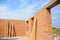 Unfinished brick house construction. Building new brick house with concrete lintel and with unfinished ceiling, roof.