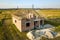 Unfinished brick house with wooden roof structure under construction