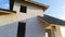 Unfinished frame of private house with aerated lightweight concrete walls and metal rooftop under construction.