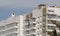 Unfinished residential building with balconies at a construction site.