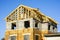 Unfinished residential house with brick and block walls and a wooden beam roof structure