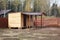 Unfinished wooden barn with shed