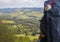 Unfocused backpack with pilgrim shell on mountain background. Pilgrimage concept. Pilgrim on Camino de Santiago road.