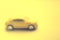 Unfocused blurred yellow car closeup, side view
