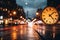 An unfocused image of an urban road at nighttime, filled with moving cars and a clock-bearing structure on the