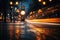 An unfocused image of an urban road at nighttime, filled with moving cars and a clock-bearing structure on the