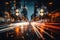 An unfocused image of an urban road at nighttime, filled with moving cars and a clock-bearing structure on the