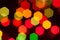 Unfocused multicolored lights with geometric shape on blurred dark background