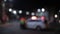 Unfocused shot of police car and officer at night. Road traffic accident concept. Street lamp lights bokeh