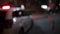 Unfocused shot of police car and traffic cones at night. Road traffic accident concept. Street lamp lights bokeh