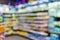 Unfocused shot of supermarket interior. Blurry hypermarket, mall or shopping center