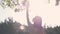 An unfocused silhouette of a young beautiful woman, who tries to touch leaves on a tree