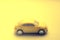 Unfocused yellow car in blurred sunny surface, side view
