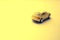 Unfocused yellow toy car on the yellow space