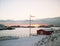 Unfrozen lake, snowy road and snow mountains, Scandinavian house, winter in Norway