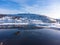 Unfrozen sea against the backdrop of snow-capped mountains. view from above