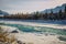 Unfrozen turquoise Katun river in Altai mountains on a frosty winter day. Incredible mountain valley landscape in sunlight