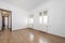 Unfurnished living room with white aluminum windows, chestnut