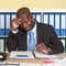 Unhappy african businessman at office