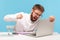 Unhappy aggressive man office worker screaming holding fist clenched, going to hit laptop display, bugs and errors in operating