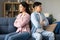 Unhappy Asian Spouses On Couch Sulking After Quarrel At Home