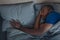 Unhappy Black Man Touching Pillow Lying In Bed Indoor