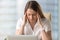 Unhappy businesswoman suffering from strong chronic headache, to