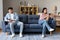 Unhappy Chinese Spouses Sulking And Using Smartphones Sitting At Home