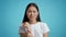 Unhappy Chinese Woman Massaging Aching Wrist On Blue Background