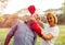 Unhappy Couple love fighting in boxing red gloves on park background. Problems in relationship, breakup