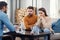 Unhappy couple sitting on sofa at therapy session in therapists office