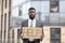 Unhappy despaired african american businessman lost work holding placard with help word outside