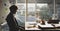 Unhappy distressed Caucasian businessman sitting and looking at a laptop on the working table. He was layoff from the company