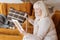 Unhappy elderly woman holding a photograph