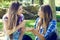 Unhappy female friends arguing in park