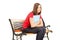 Unhappy female student sitting on a wooden bench with notebook