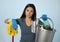 Unhappy and frustrated housekeeping woman holding mop and wash bucket as hotel cleaner service or house maid