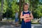 Unhappy girl with a book does not want to go to school. Mother sends daughter to first grade. The first day in