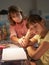 Unhappy Girl Looking At Diary In Bedroom At Night