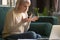 Unhappy grey haired mature woman having problem with laptop at home