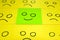 Unhappy and happy concept. Background of blue and green sticky notes. Happy sticky note is among unhappy sticky notes