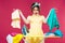 Unhappy irritated young woman holding and ironing clothes